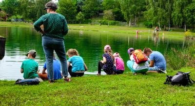 Gruppe von Kindern und Erziehern erforschen den Allmendsee